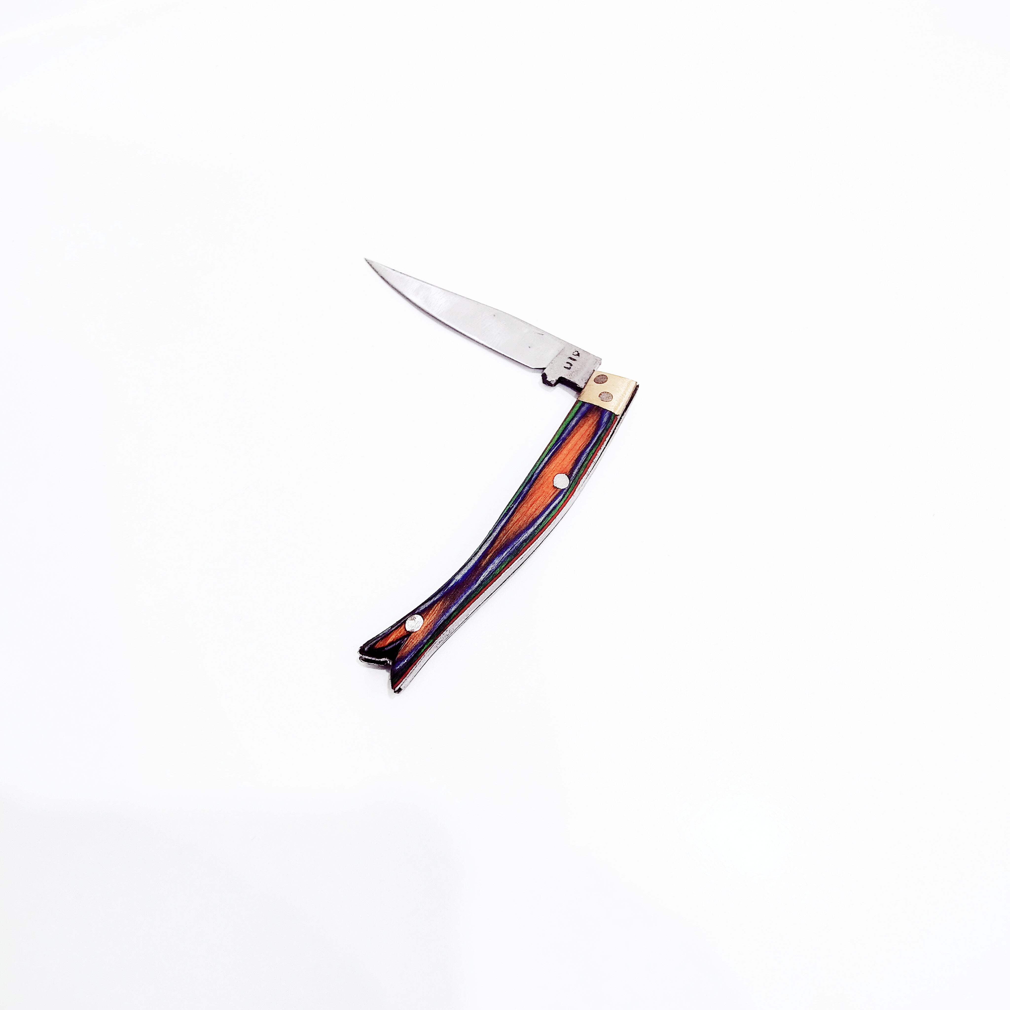 Folding knife with a multicolored handle on a white background